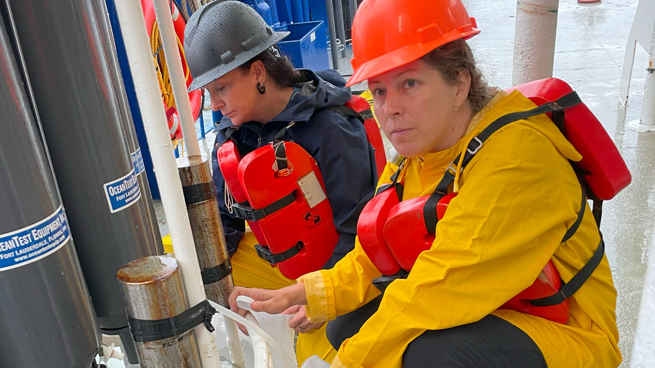 Brandi Kiel Reese collecting a water sample.